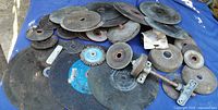 Assorted abrasive and stone disks spread out on surface
