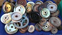 Top view of full assortment of pulleys on blue cloth