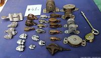 Full lot overview showing all pulleys and rope clips on blue surface