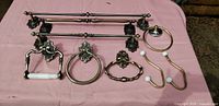 All bath hardware laid out on pink cloth