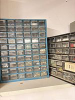Blue and black plastic parts organizers side by side showing overall form and drawer counts