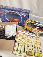 Overall lot showing boxed Nantucket kit, Super Train set, Bachmann accessory pack, loose trestles, cleaner items
