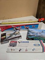 Overall lot showing four boxed items including balancer and three model kits