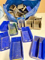 Assorted plastic bins spread on table and in bag