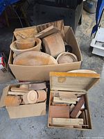 large box with multiple rough-turned bowls and trays