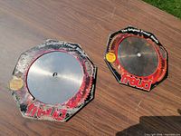 Two Freud blades in sleeves on table