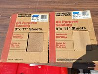 Front view of both Norton sandpaper boxes showing size and type