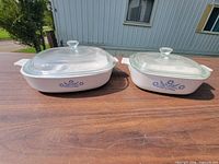 Two Cornflower Blue casseroles with lids side by side