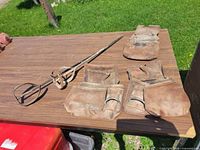All items shown on table: three leather pouches and two mixing paddles