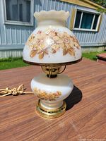 Full view of electric hurricane lamp assembled on table