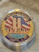 Obverse of enameled commemorative token showing Twin Towers and U.S. flag