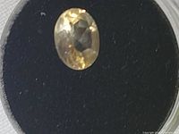 Top view of oval citrine gemstone inside display case