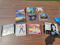 Group view of all CDs and box set laid on table
