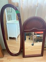 Both mirrors standing side by side on floor