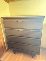 Front view of four-drawer dresser showing overall design and finish