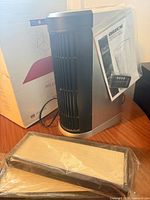 Full view of purifier with sealed filter, remote, manual and box