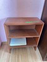 Front view of brown wooden bookshelf showing two shelves