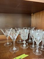 Group of clear cut crystal stemware on shelf