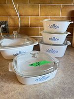 Group view of all CorningWare dishes showing size range and lids