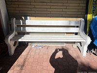 Front view of concrete and wood garden bench showing full structure