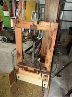 Full view of wooden wine press standing in garage