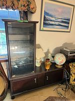Full view of media cabinet next to other items