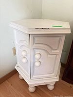 Full view of white corner nightstand closed