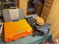 Overall view of two hard cases, Makita soft bag, leather and canvas pouches