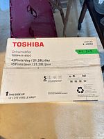 Top of sealed Toshiba dehumidifier carton with model and capacity info