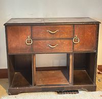 Front view showing drawers, hardware, and open lower cubbies