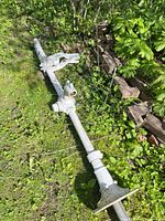 Full view of cast iron irrigation pump lying on grass