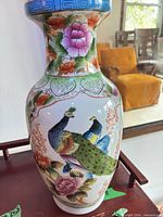 Full view of porcelain vase showing decorative peacocks and floral motifs