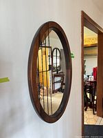 Full view of oval mirror on wall