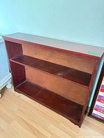 Front view of wooden shelf showing two shelves and condition