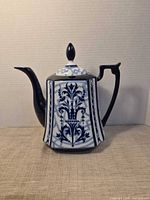 Front view of blue and white floral transferware porcelain teapot with lid