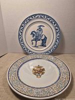 Two porcelain plates shown upright and flat