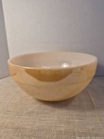 Exterior view of beige ceramic mixing bowl