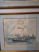Framed artwork close view showing ship and background