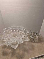Large frosted ruffled bowl beside small printed bowl
