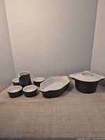 Full set arranged showing casserole with lid, baking dish, ramekins, and pitcher