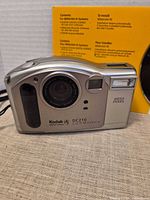 Front view of Kodak DC210 camera showing lens, flash, viewfinder and DC210 branding