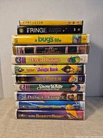 Full stack showing all 11 titles from Beauty and the Beast at bottom to Contagion at top