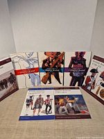 Group shot showing three Umbrella Academy TPBs flanked by Osprey military softcovers