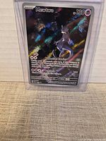 Front of sleeved Mewtwo card showing holographic finish and HP 130