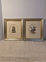Pair of framed cross-stitch embroideries side by side