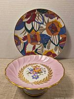 Front view of both porcelain items showing designs and colors