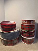 Stacks of ribbon spools showing plaid and grey velvet rolls