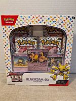 Front of sealed Alakazam EX Collection box showing contents