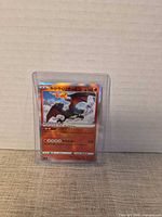 Front view of Japanese Kagayaku Charizard card in toploader