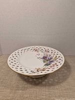 Full view of pedestal cake stand showing lattice rim and floral design